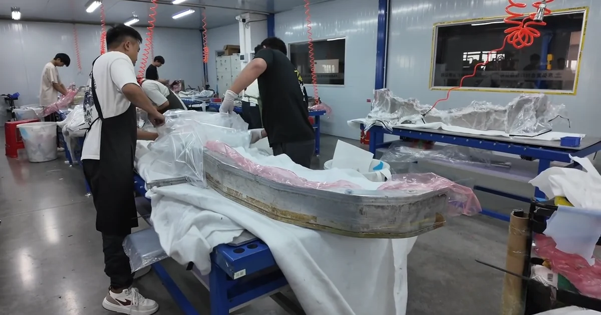 Carbon fiber automotive part mold being prepared in the workshop.