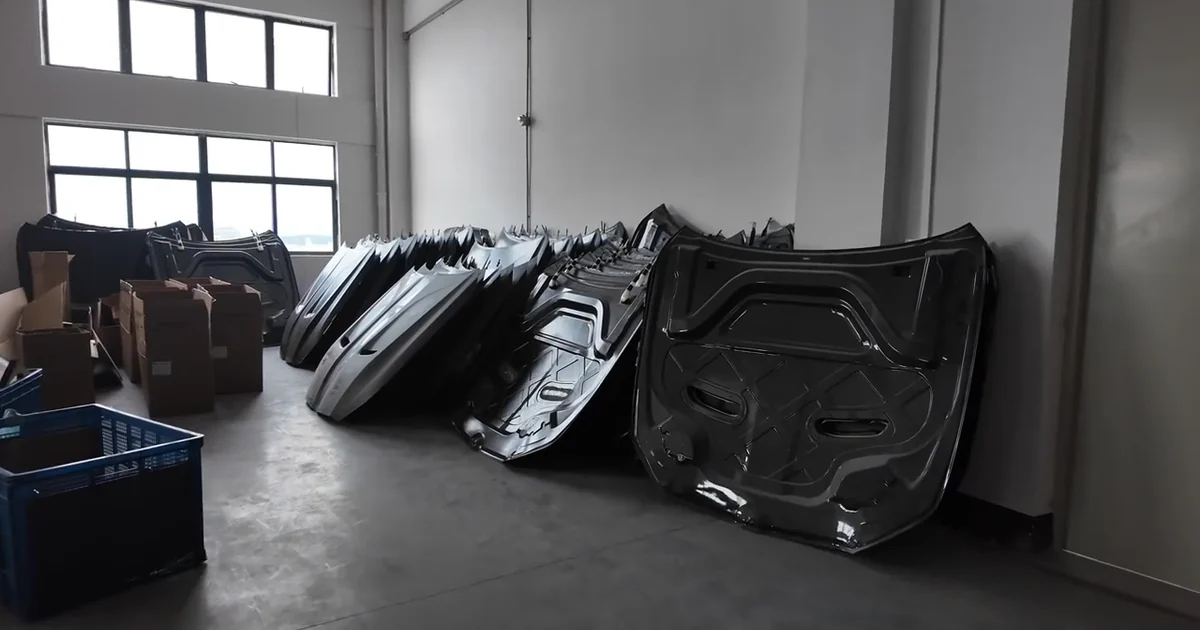 Finished carbon fiber automotive panels stored inside the workshop before packing.
